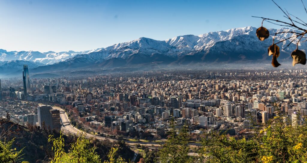 A panoramic view of a city with mountains in the background