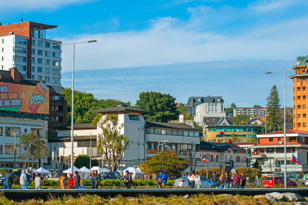 a group of people standing on the side of a river